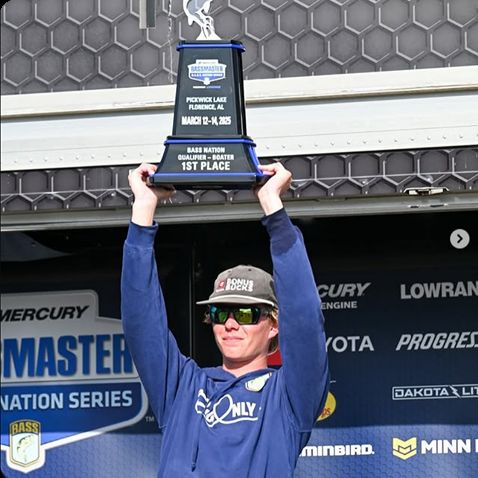 Dylan Nutt hoisting a first-place trophy